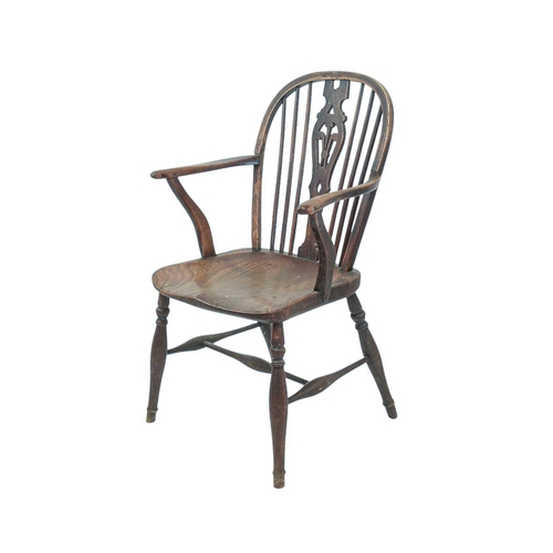 519 - An ash and elm Windsor armchair. 19th century, the central splat pierced with Fleur-De-Lys, the arms... 