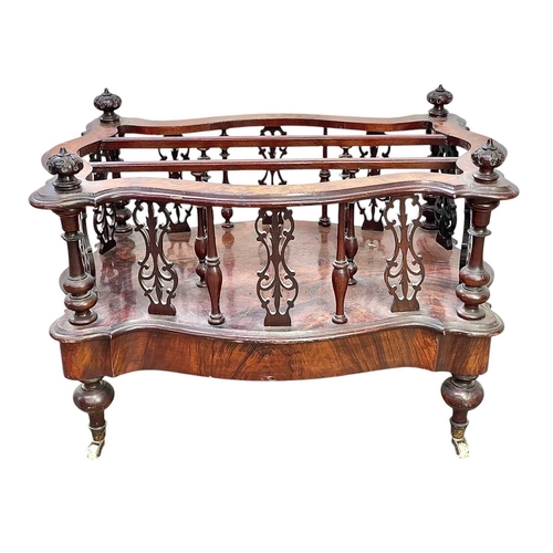 520 - A Victorian walnut serpentine Canterbury or magazine rack. With scroll inlaid top, turned and pierce... 