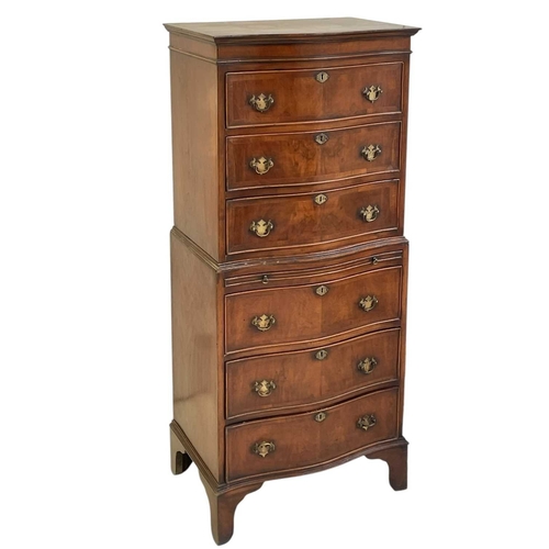 521 - A mahogany dwarf serpentine front two part chest on chest. Fitted with six long drawers and a brushi... 