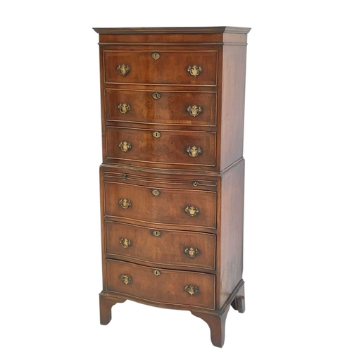 521 - A mahogany dwarf serpentine front two part chest on chest. Fitted with six long drawers and a brushi... 