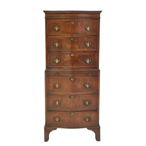 521 - A mahogany dwarf serpentine front two part chest on chest. Fitted with six long drawers and a brushi... 