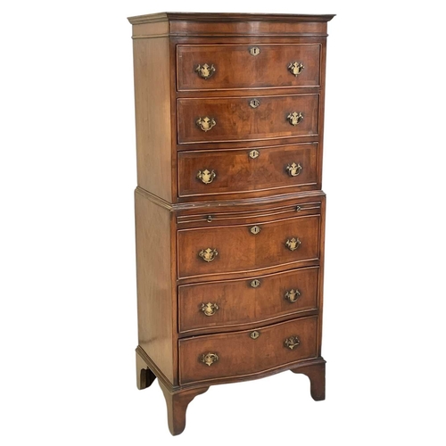 521 - A mahogany dwarf serpentine front two part chest on chest. Fitted with six long drawers and a brushi... 