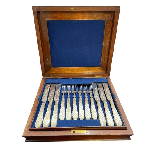 63 - A cased Victorian mother of pearl dessert set. Twelve knives and forks, with scroll and foliage deco... 