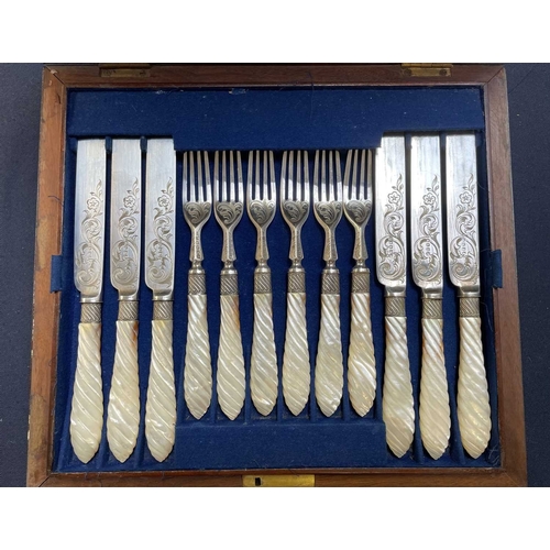 63 - A cased Victorian mother of pearl dessert set. Twelve knives and forks, with scroll and foliage deco... 