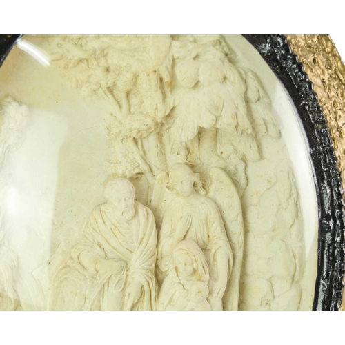 65 - A 19th century oval plaster relief biblical scene. Moulded with the holy family, within a glazed mou... 