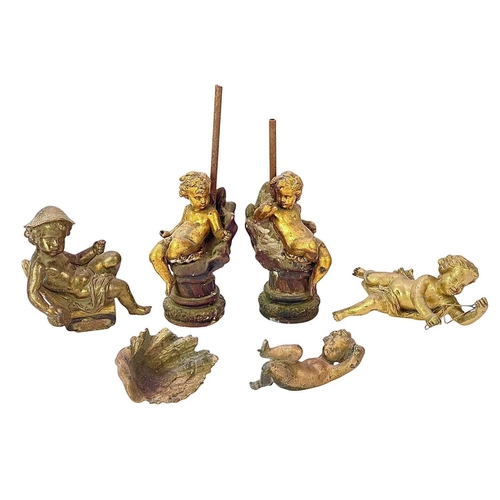 68 - A pair of gilt metal cherub lamp bases. Circa 1900, each upon a plaster shell, height 30cm, together... 