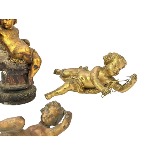 68 - A pair of gilt metal cherub lamp bases. Circa 1900, each upon a plaster shell, height 30cm, together... 