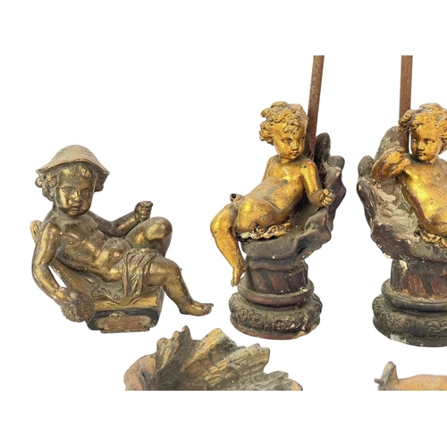 68 - A pair of gilt metal cherub lamp bases. Circa 1900, each upon a plaster shell, height 30cm, together... 