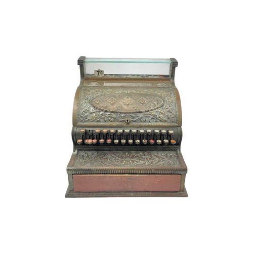 69 - A late 19th century American National cash register. In an ornate cast brass case, with applied labe... 