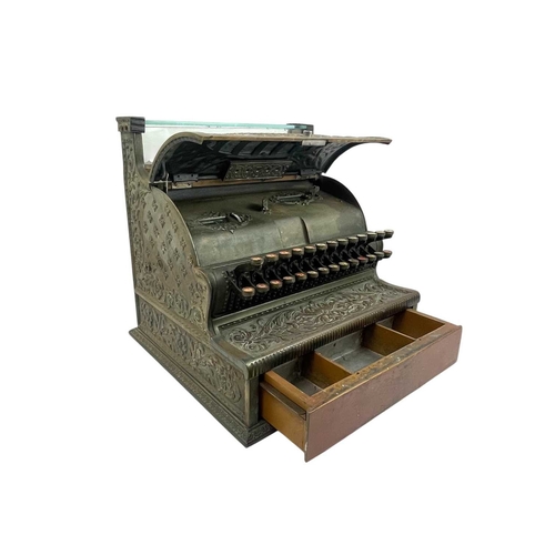 69 - A late 19th century American National cash register. In an ornate cast brass case, with applied labe... 