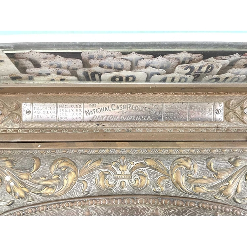 69 - A late 19th century American National cash register. In an ornate cast brass case, with applied labe... 