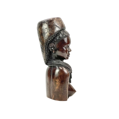 9 - An Angolan carved hardwood bust of a woman. Carved 'M. Rafael' to the top and 'Amo' to the front, he... 