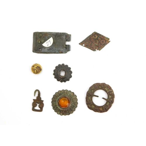 279 - A collection of metal detecting finds. Including a Victorian costume button, a medieval buckle plate... 