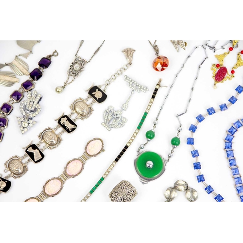 286 - A selection of Art Deco period costume jewellery. To include a white metal Egyptian revival bracelet... 