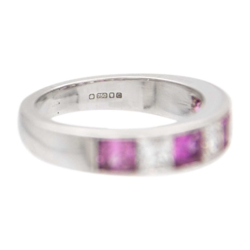 102 - A pink sapphire and diamond channel set 18k white gold band ring. Four princess-cut sapphires with f... 