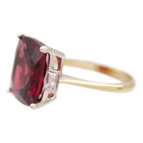 103 - A Rhodolite garnet and diamond 18k gold dress ring. The square cushion-cut purplish red garnet is 12... 