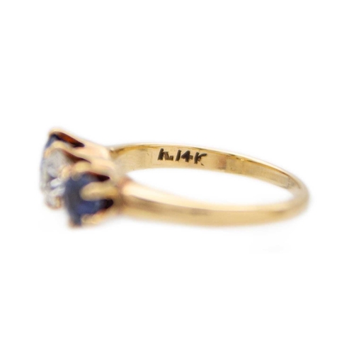 107 - A three-stone diamond and sapphire 18k yellow gold ring. The brilliant-cut white diamond is 0.30ct a... 