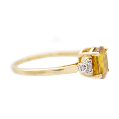 120 - A 9k gold sphene (titanite) and diamond ring. The oval mixed-cut golden sphene is 8mm x 6mm, set wit... 