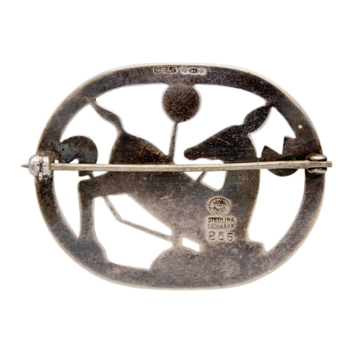 131 - ARNO MALINOWSKI FOR GEORG JENSEN. A silver oval openwork brooch, depicting a kneeling deer with foli... 