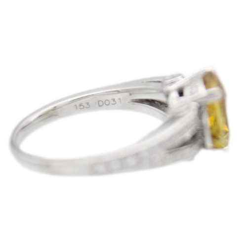 175 - A golden chrysoberyl and diamond platinum ring. The oval mixed-cut chrysoberyl is 8mm x 9mm, with ac... 