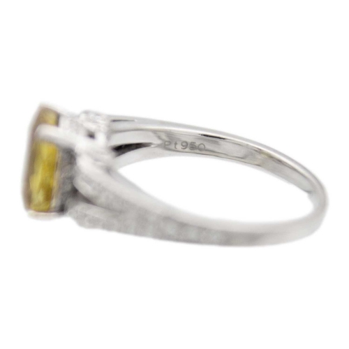 175 - A golden chrysoberyl and diamond platinum ring. The oval mixed-cut chrysoberyl is 8mm x 9mm, with ac... 