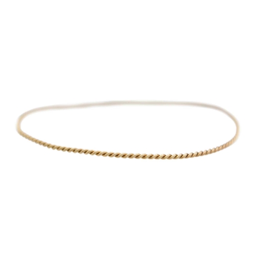 89 - A 9k gold twisted design bangle with two twist stacking rings. The bangle is 6.5cm in diameter, fanc... 