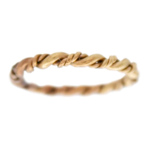 89 - A 9k gold twisted design bangle with two twist stacking rings. The bangle is 6.5cm in diameter, fanc... 