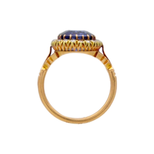 95 - An 18k rose gold synthetic blue sapphire and diamond set halo ring. The stone is approx 4.5ct (1cm i... 