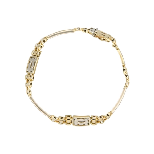 97 - A modern 14k two-tone gold (tested) bracelet. With intertwinned CC monogram panels, links and rectan... 