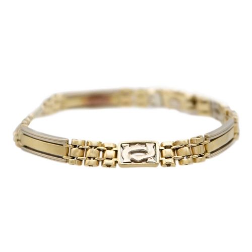 97 - A modern 14k two-tone gold (tested) bracelet. With intertwinned CC monogram panels, links and rectan... 