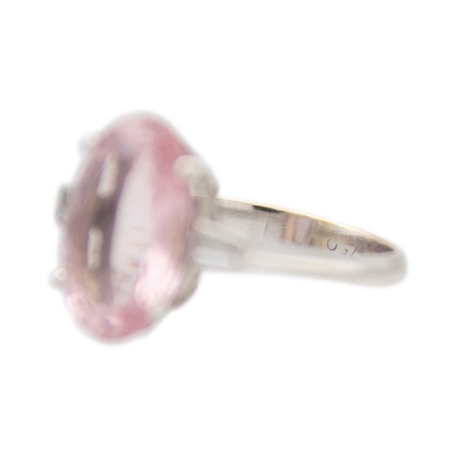 98 - A pale pink tourmaline and diamond 18k white gold ring. The oval mixed-cut tourmaline is 19mm x 10mm... 