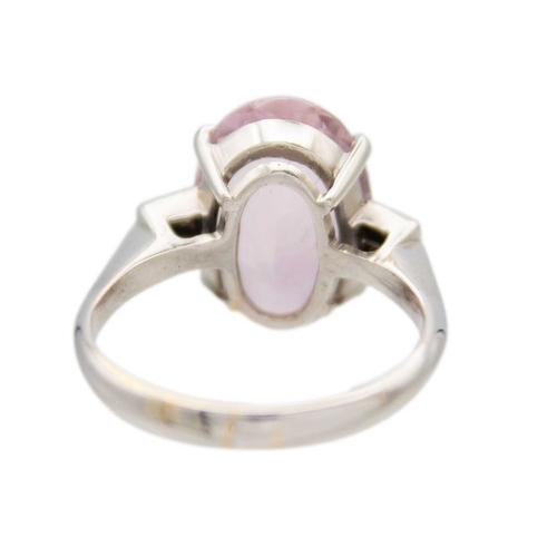 98 - A pale pink tourmaline and diamond 18k white gold ring. The oval mixed-cut tourmaline is 19mm x 10mm... 