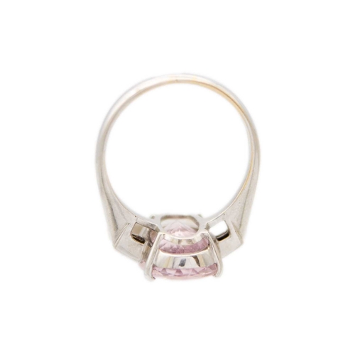 98 - A pale pink tourmaline and diamond 18k white gold ring. The oval mixed-cut tourmaline is 19mm x 10mm... 