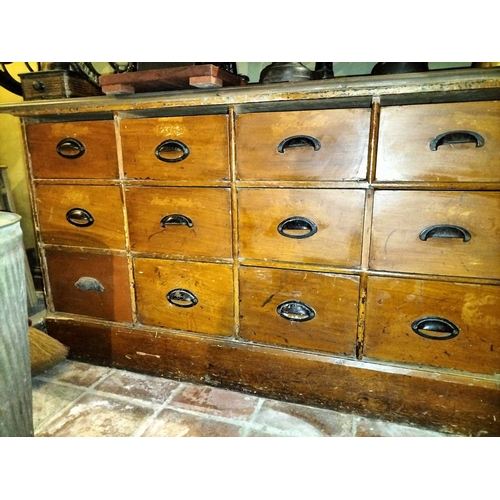 112 - ± Clemence's Ironmongers Nest of drawers A nest of 15 shop storage drawers HxWxD 78x161x25cm