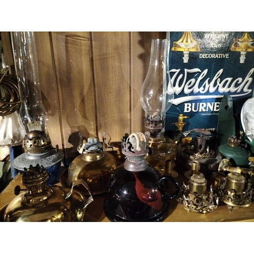 119 - ± Clemence's Ironmongers A collection of oil lamp burners and parts A large collection of oil lamp p... 