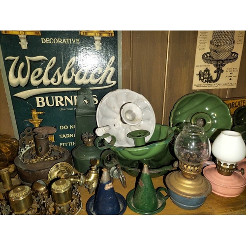 119 - ± Clemence's Ironmongers A collection of oil lamp burners and parts A large collection of oil lamp p... 