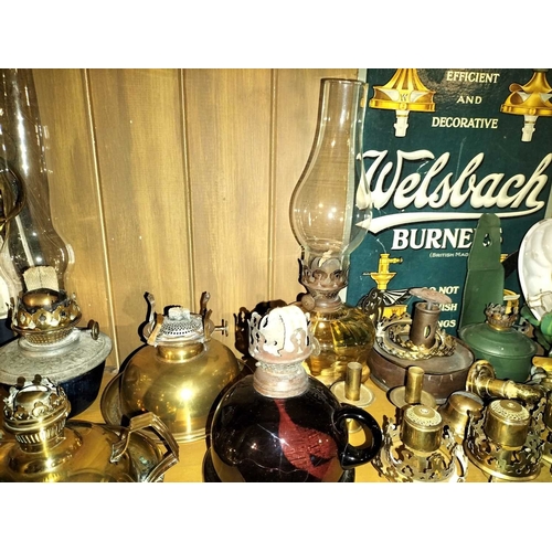 119 - ± Clemence's Ironmongers A collection of oil lamp burners and parts A large collection of oil lamp p... 