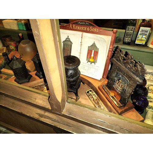 154 - ± Clemence's Ironmongers A Kenrick and sons a shop window display incorporating miniature stoves and... 