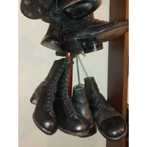 177 - ± Public Benefit Boot Company Six pairs of Victorian and later boots Hanging from a display wood and... 