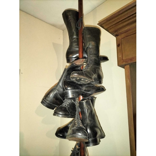 177 - ± Public Benefit Boot Company Six pairs of Victorian and later boots Hanging from a display wood and... 