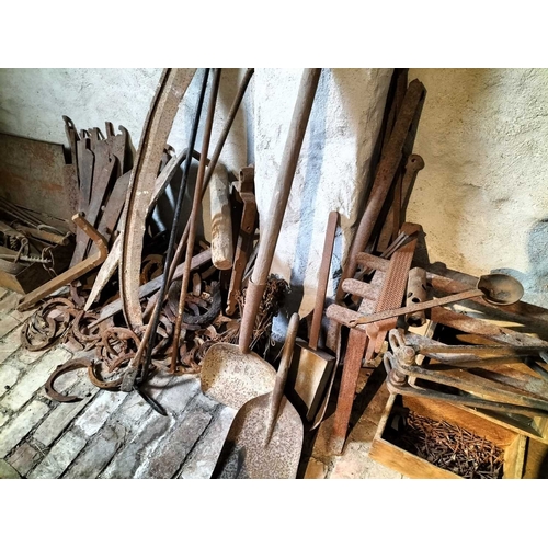 212 - ± Wiltshire & Son Blacksmiths ironwork A collection of ironwork including a bench, tools,horse shoes... 