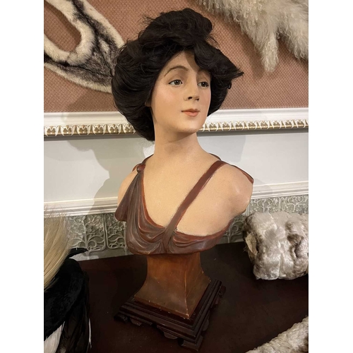 228 - ± Furrier & Plumassier Display Bust A plaster cold-painted belle epoch bust with a dark wig and extr... 