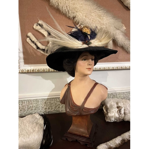 228 - ± Furrier & Plumassier Display Bust A plaster cold-painted belle epoch bust with a dark wig and extr... 