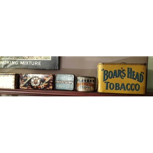 273 - ± M King Tobacconist Collection of tobacco tins and packaging A shelf of tins including Boars Head,P... 