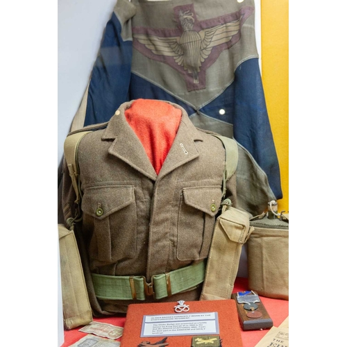 1176 - ± The War Gallery Arnhem The Arnhem display case contents to include,Parachute Regiment flag, unifor... 