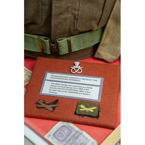 1176 - ± The War Gallery Arnhem The Arnhem display case contents to include,Parachute Regiment flag, unifor... 