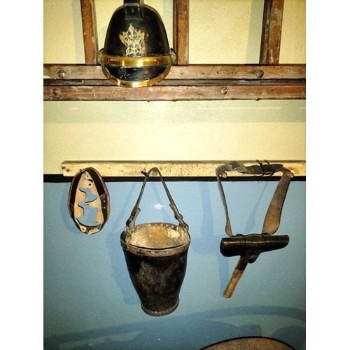 308 - ± Flambards Fire Station Six items from the Fire Station A leather and brass fireman's helmet, a lea... 