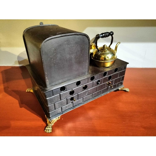 505 - ± Mr Neville's Toyshop Gebruder Bing manner, a tin and brass stove A toy stove with brass fittings p... 