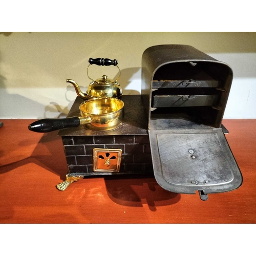 505 - ± Mr Neville's Toyshop Gebruder Bing manner, a tin and brass stove A toy stove with brass fittings p... 