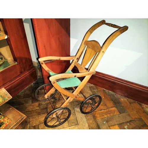 510 - ± Mr Neville's Toyshop Childs Pram and three other wheeled toys An interesting early painted wood an... 